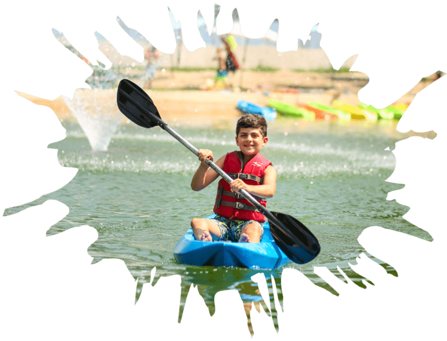 A young boy paddling a kayak