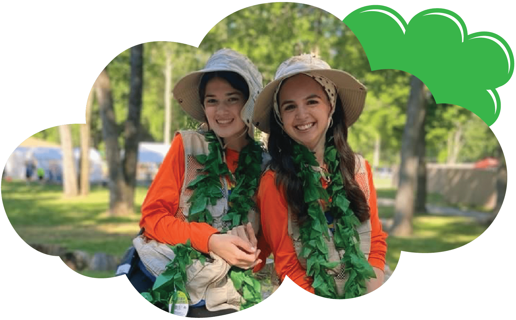 Two female Regesh staff members smiling in luau outfits